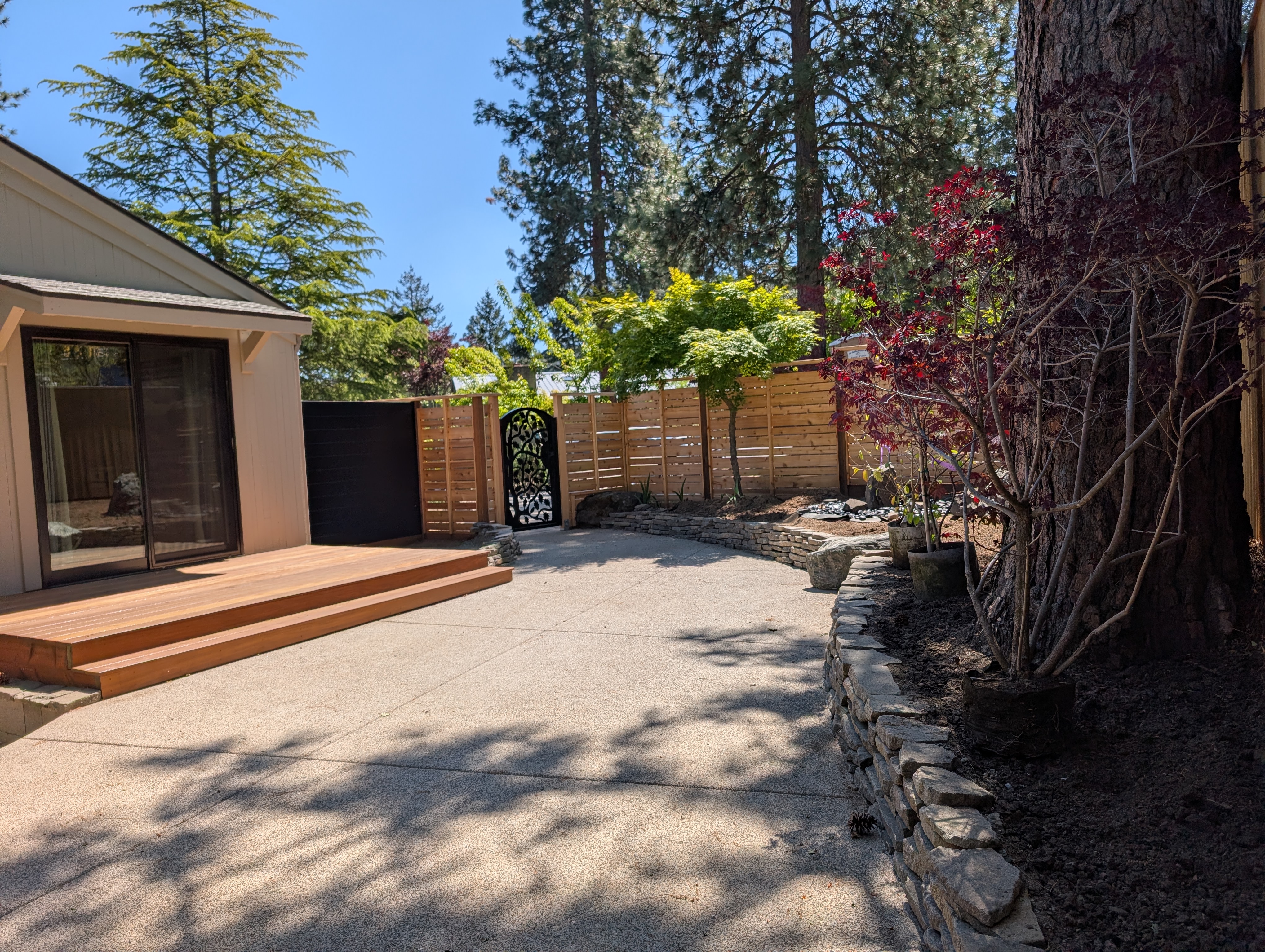 Completed cedar fence and decorative gate with finished backyard
